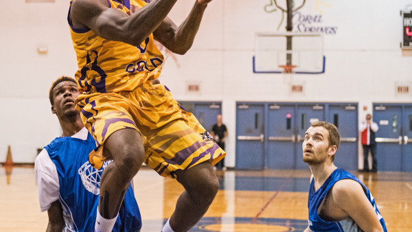 A basketball player jumping in the air to dunk.